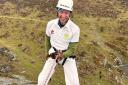 Abseiler in cricket whites