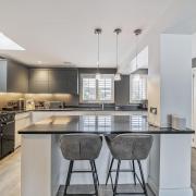 The finely-appointed kitchen has a sleek, contemporary look