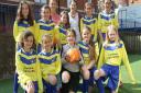 Franklins on the Strand have sponsored one lot of new football kit for children at the Beacon primary school. India Haywood from Franklins is pictured with some of the youngsters in their smart new kit and their PE co-ordinator Amanda Pow. Ref exe 20-16SH