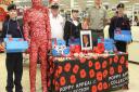 Exmouth Sea and Royal Marine Cadets helped sell poppies at the Exmouth Tesco's Salterton Road store on Saturday. The group are picturted with the life sized Remembrance Poppy figure created by RBL committee member Carole Reeves  and Zena Lowe. Ref exe 541