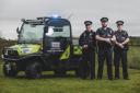 Police officers with a new all terrain police vehicle