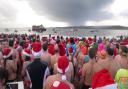 Swimmers line up ready to dash for the sea in Exmouth on Christmas Day 2013. Ref exe 0451-52-13SH