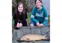 Summer Skelly and Evie Stewart with a mid double figure common carp from Newbarn