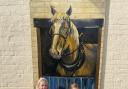 Sennen and Roux Carroll with their paintings of horses