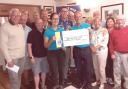 Budleigh Lions present the cheque to Martin Briggs and Claire Jones