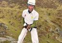 Abseiler in cricket whites