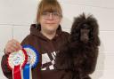 Kathryn Sellick with puppy Bueno and her awards for grooming and handling