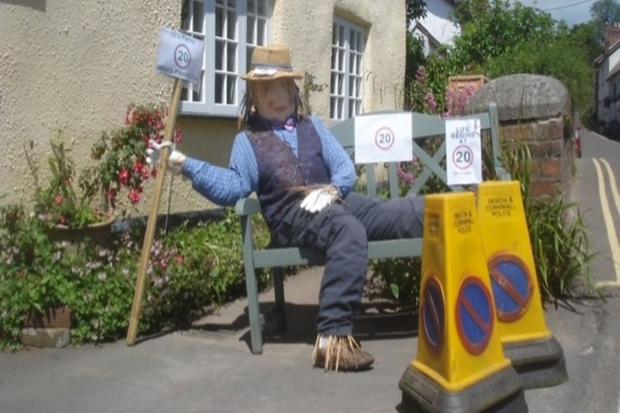 A scarecrow with a message at a previous festival