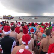 Swimmers line up ready to dash for the sea in Exmouth on Christmas Day 2013. Ref exe 0451-52-13SH