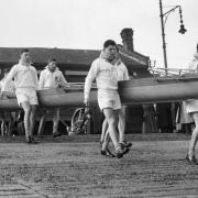 Rodney Dingle (front row, third from left) with the Cambridge crew, carrying their boat out before the 1952 Boat Race.