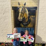 Sennen and Roux Carroll with their paintings of horses