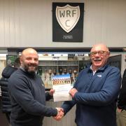 RNLI Crew Member & Withy Coach Jason Luff presenting the certificate to Withy Chairman, Merv Richards