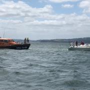 The RNLI with the damaged yacht