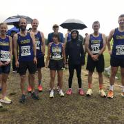 Harriers braving the rain before the start of the Run Exe 5km