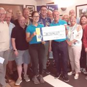 Budleigh Lions present the cheque to Martin Briggs and Claire Jones