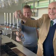 Lord Clinton pulling the first pint at the cricket club's opening event last November, with treasurer Andy Drodge