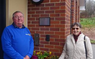 Betty Ford and Dick Francis, President of Exmouth Rotary, with the plaque at the Juniper Centre